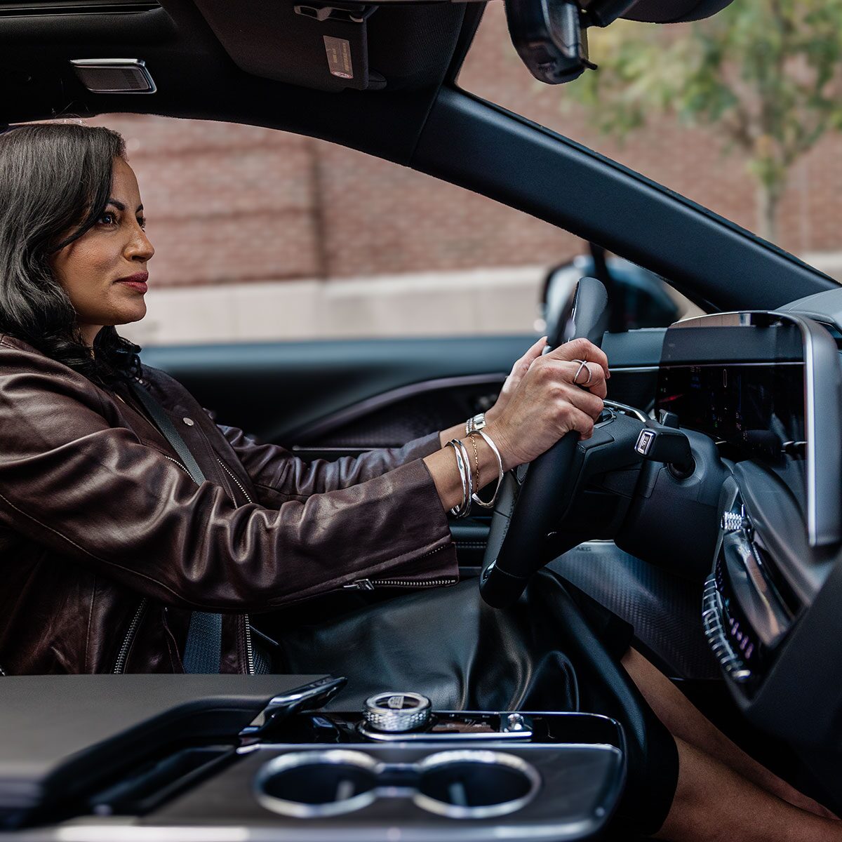 A person seated at the driver's seat of the 2027 Cadillac LYRIQ-V.
