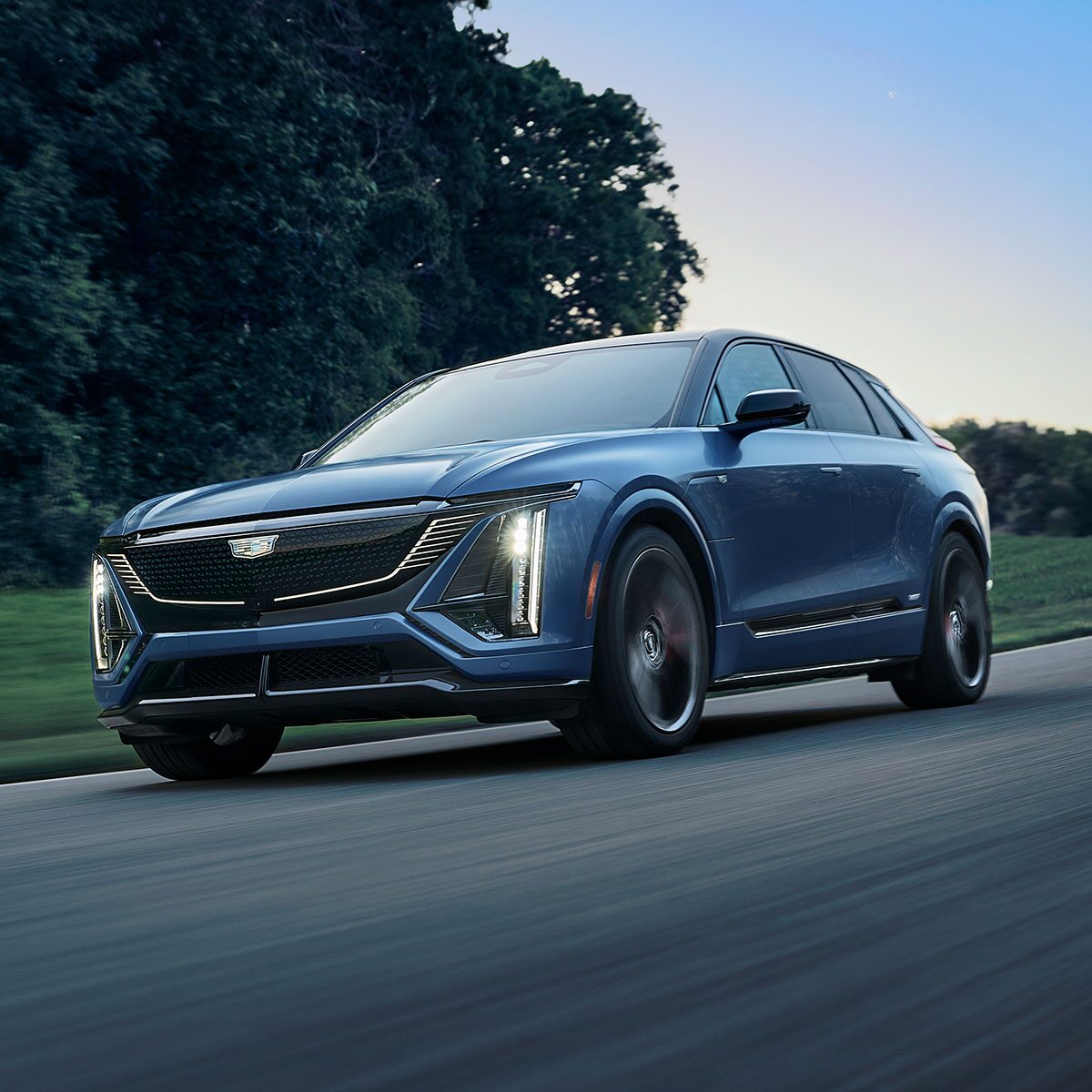 Front-side view of the 2027 Cadillac LYRIQ-V driving fast on the road.