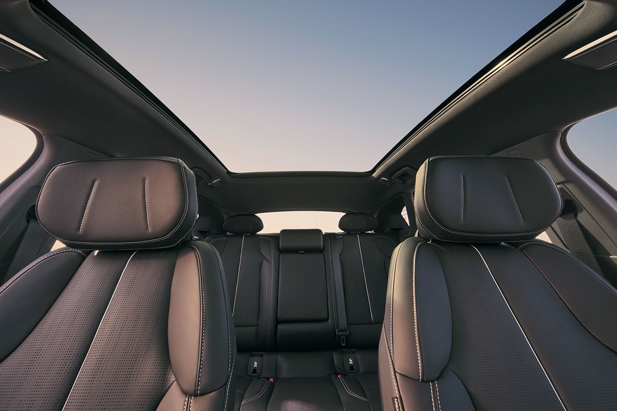 Vue du tableau de bord des deux rangées de sièges de la Cadillac OPTIQ 2027 et du toit skyglass.