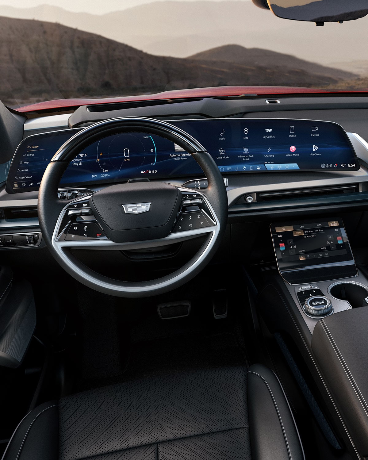 A Panoramic Interior View of a 2027 Cadillac VISTIQ's Front Row and Dashboard Outlooking the Mountains.