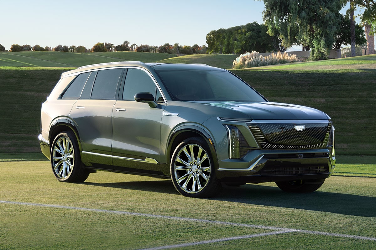Three-quarter View of a 2027 Cadillac VISTIQ Parked on a Grassy Tennis Court.