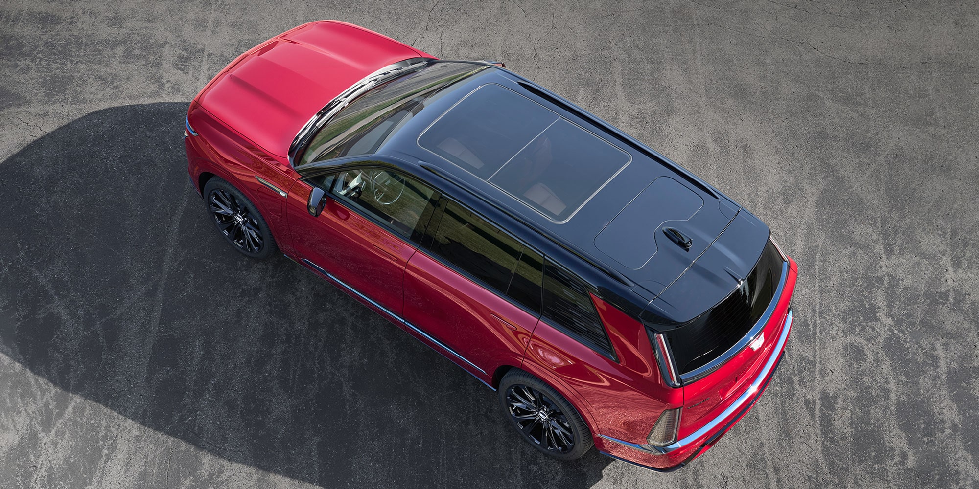 Bird's Eye View of the Top of a Red 2027 Cadillac VISTIQ Parked on a Asphalt Surface.