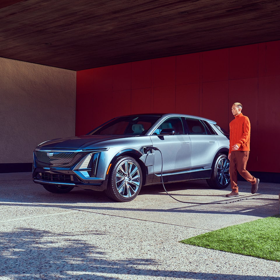 A Cadillac vehicle plugged into a charging outlet.