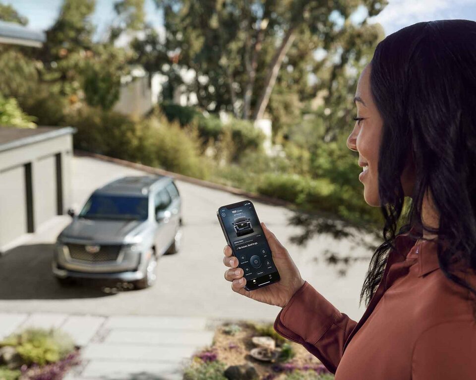 Woman using MyCadillac app.