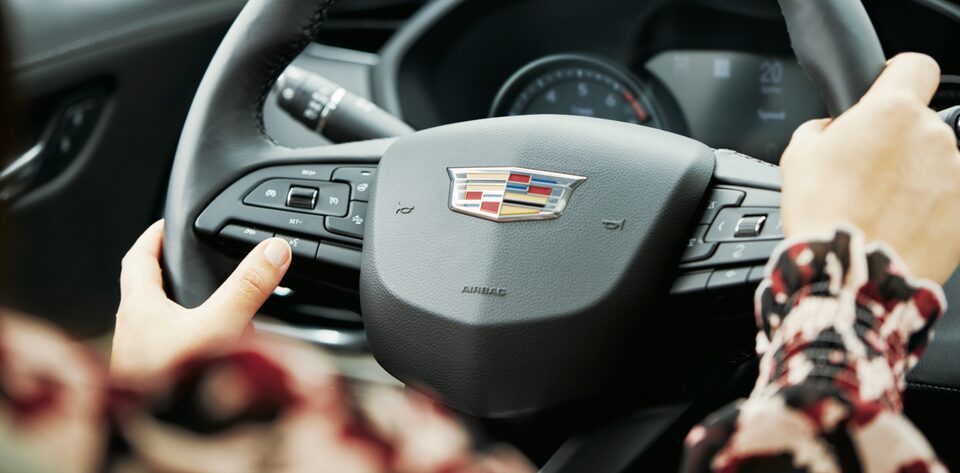 SiriusXM integration with Cadillac vehicles controlled through the steering wheel.