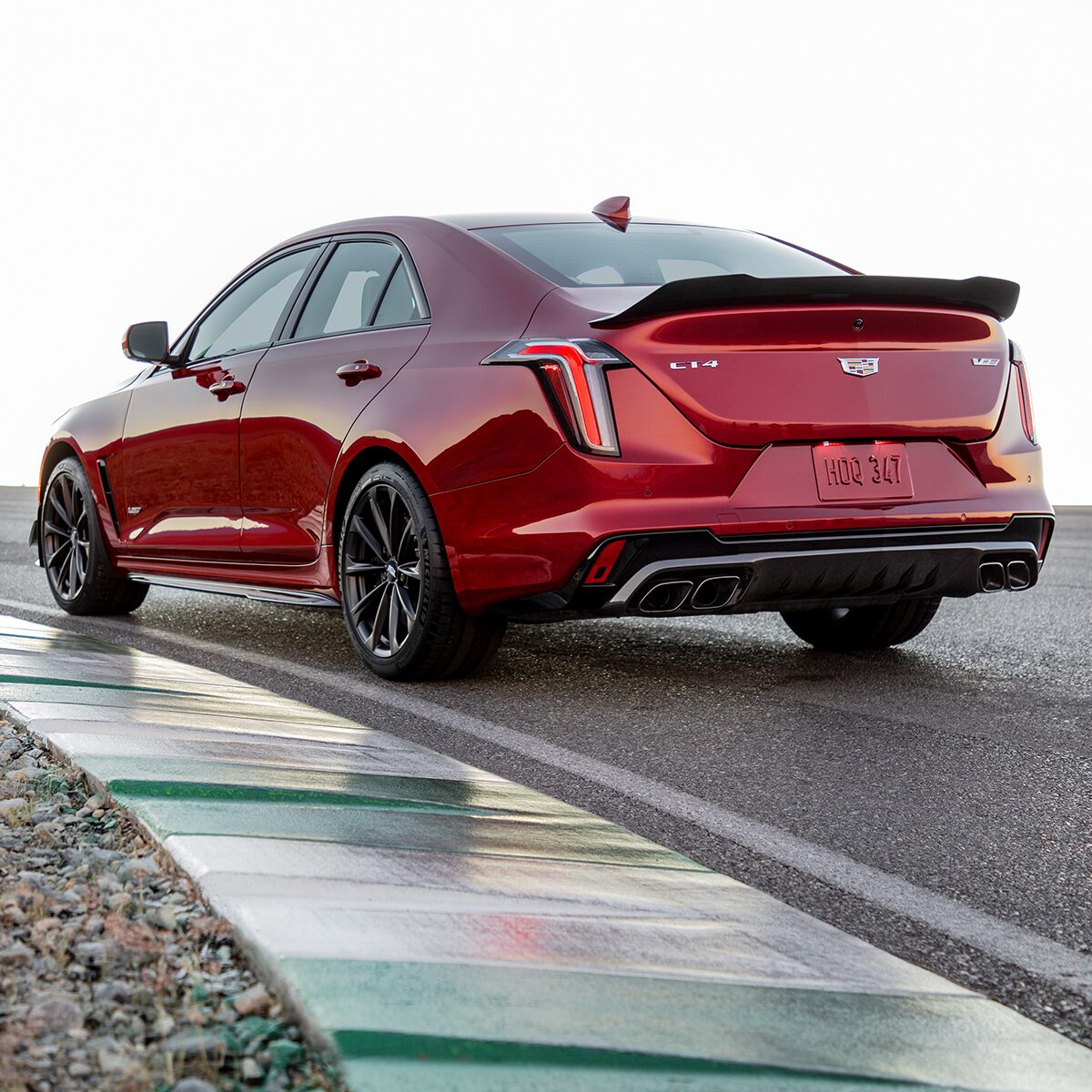Rear view of the 2023 CT4-V compact sport sedan. driving on the road.