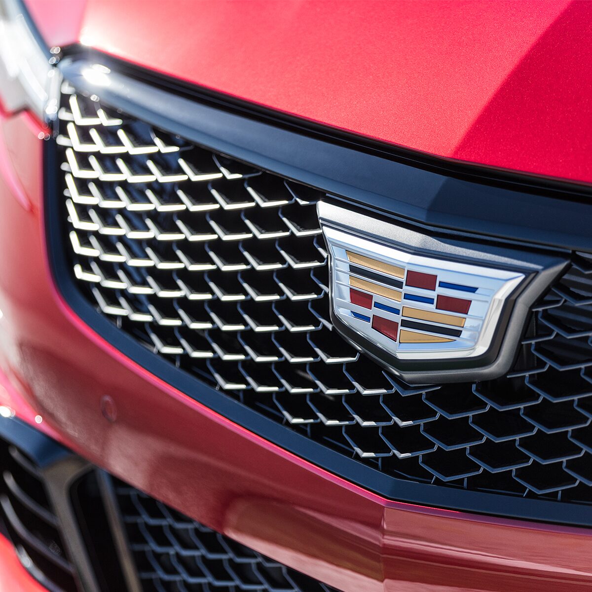 Close-up view of the  2023 CT4-V compact sport sedan grille and Cadillac insignia.