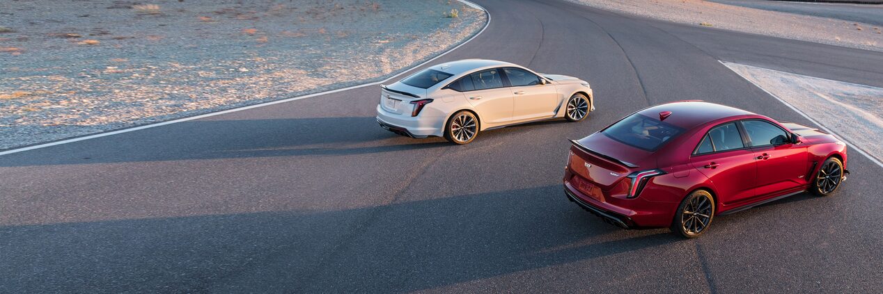 A pair of 2023 Cadillac CT4-V on the road featuring the V Performance Badge.
