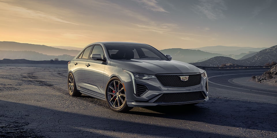 2026 Cadillac CT4-V luxury sports sedan driving durin sunrise.