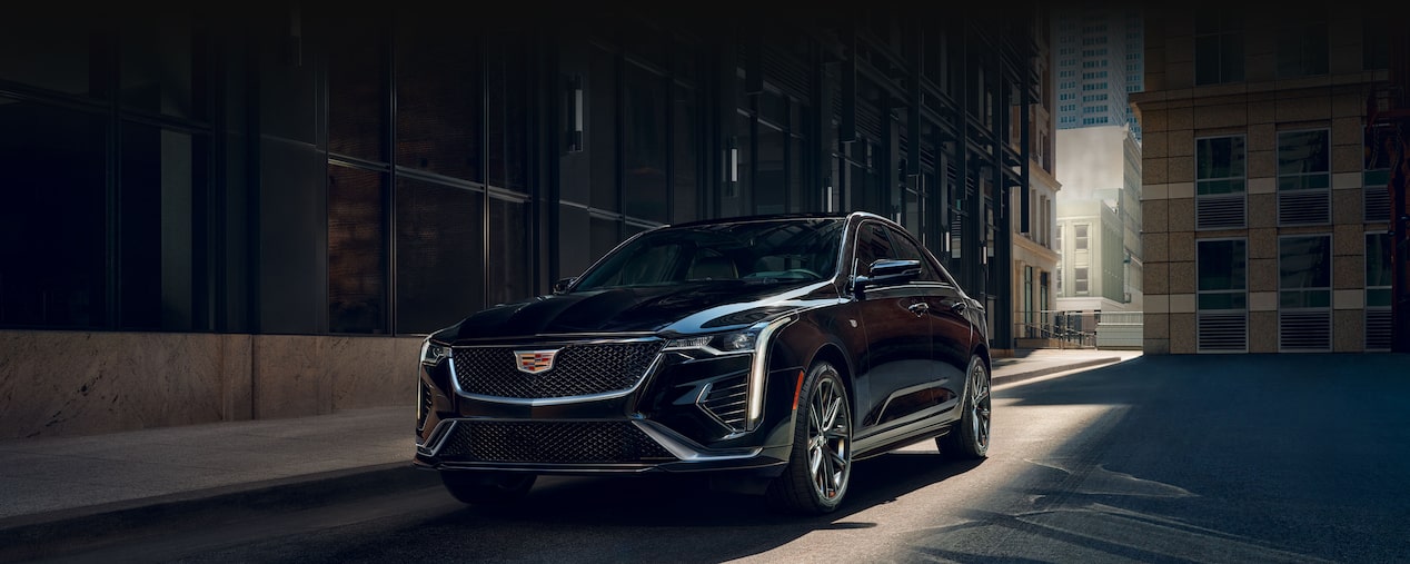 2026 Cadillac CT4 luxury sedan parked beside a building.