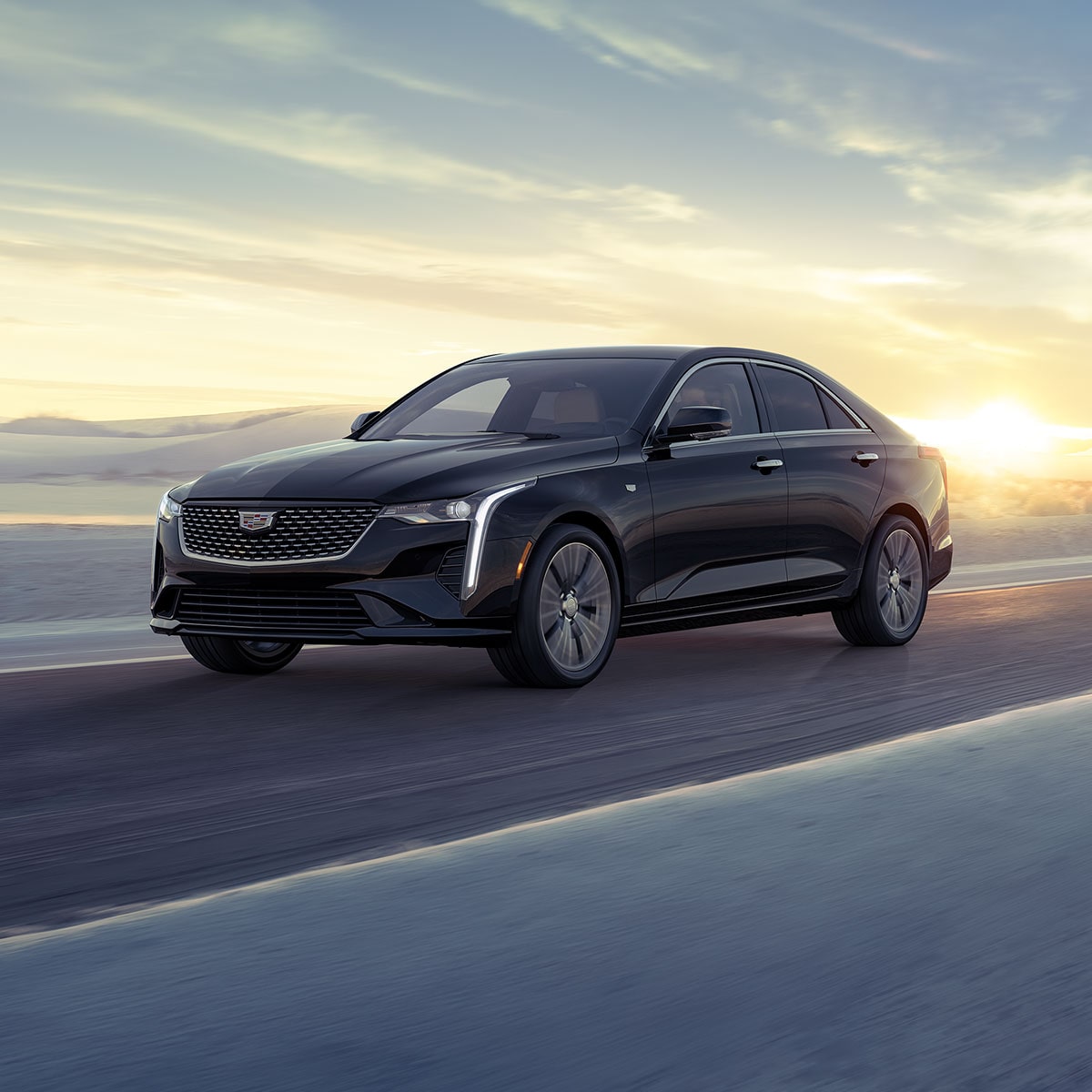 2026 Cadillac CT4 luxury sedan driving alone on a hillside road.