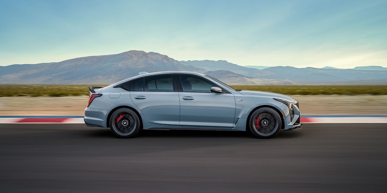 Side view of the 2026 Cadillac CT5-V driving on a countryside road.