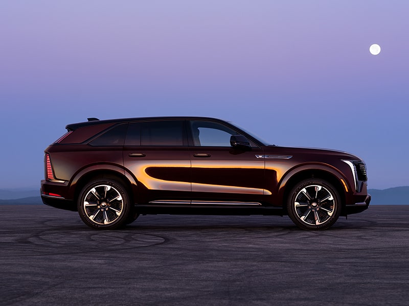 Rear Three-quarter View of a Maroon Cadillac ESCALADE IQ Parked in the Desert