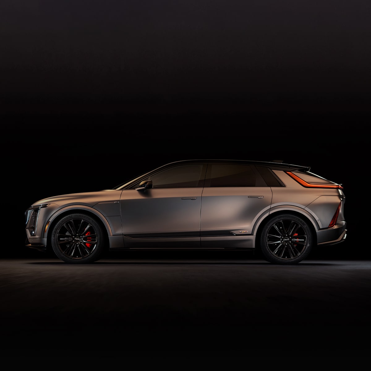 Driver's Side Profile of the Cadillac LYRIQ-V Parked in a Black Showroom