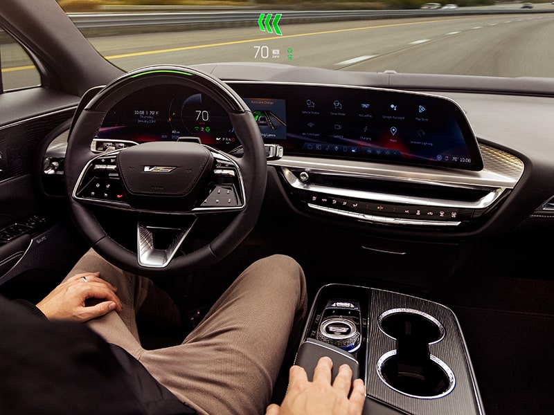 A Driver Utilizing Hands-free Super Cruise Technology While Driving a Cadillac 