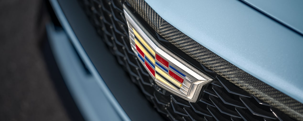 Close-up view of the Cadillac badging on the front grille of the Cadillac CT5-V Blackwing.