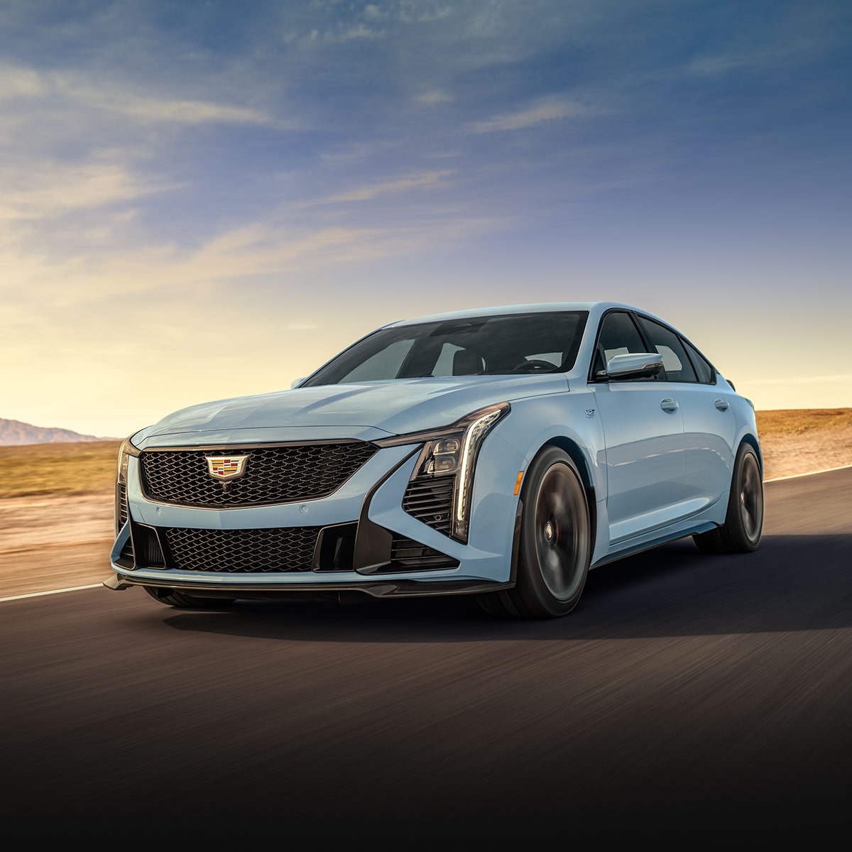 Front three-quarter view of a Cadillac CT5-V Blackwing driving alone on the road.
