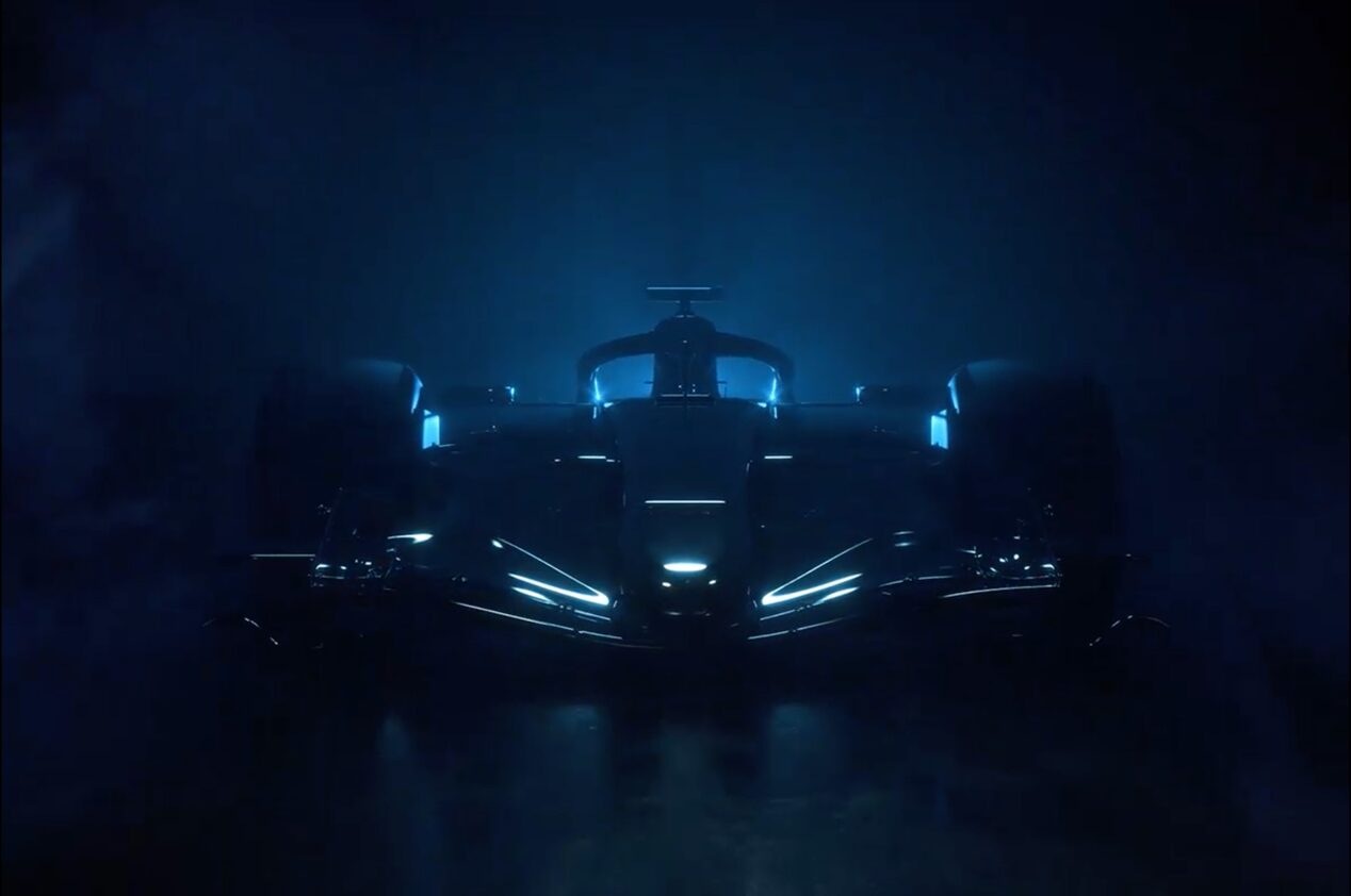 A Cadillac F1 racecar parked in a dimly lit area.