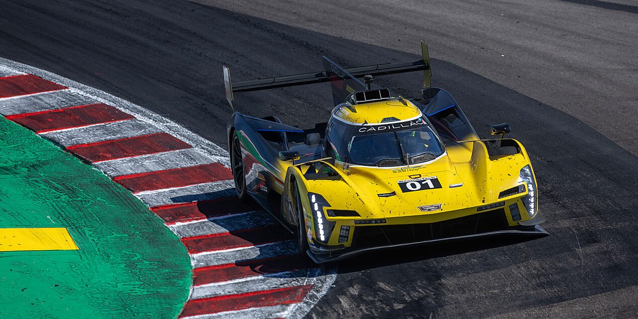 A yellow Cadillac V-Series.R racecar driving on a race track.