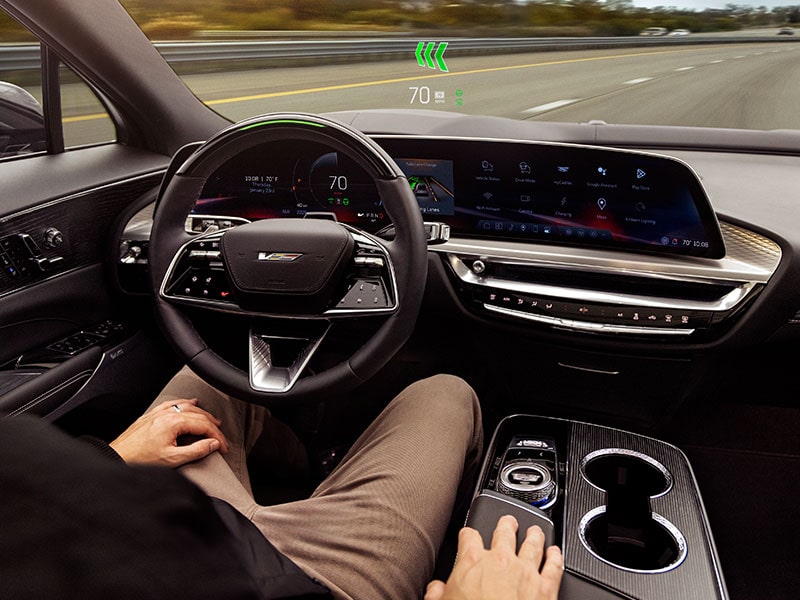 A Driver Utilizing Super Cruise Hands-free Technology in a Cadillac Driving Down the Road