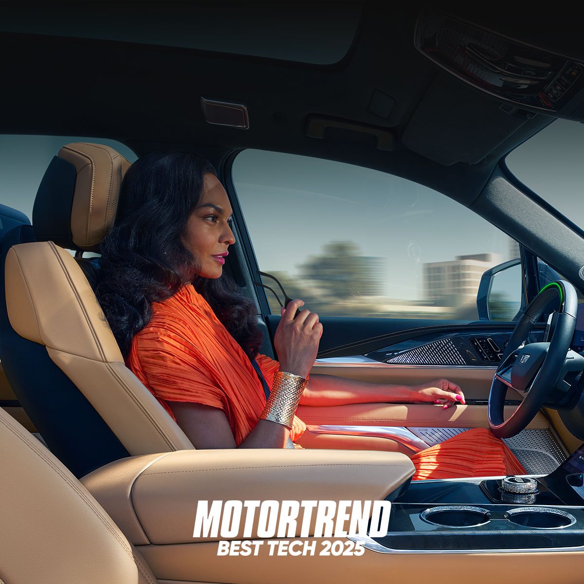 Passenger View of a Woman Driving Hands-free Utilizing Super Cruise in a Cadillac ESCALADE IQ in the City