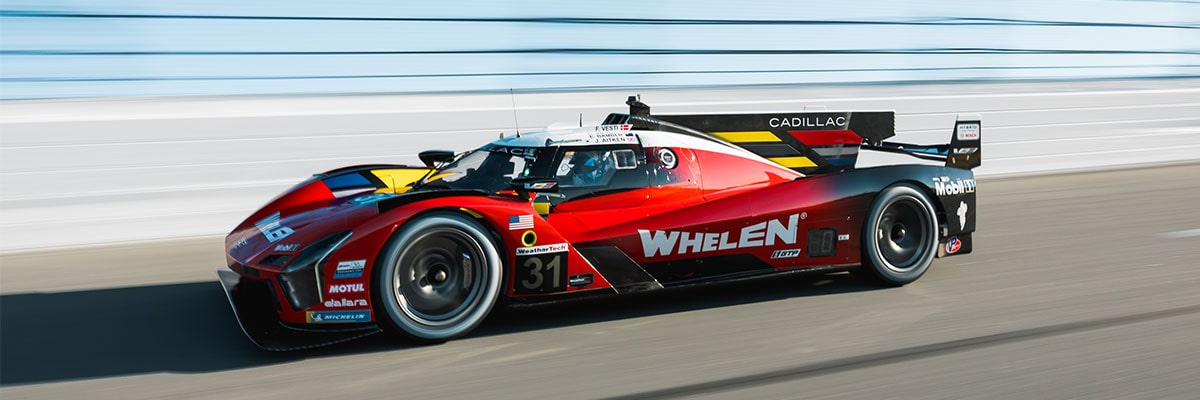 Side View of a Red Cadillac CT4-V Parked Outside of a Coffee Shop