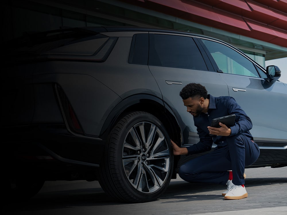 Cadillac Certified Service Technician Inspecting the Wheel on a Cadillac LYRIQ Electric Vehicle