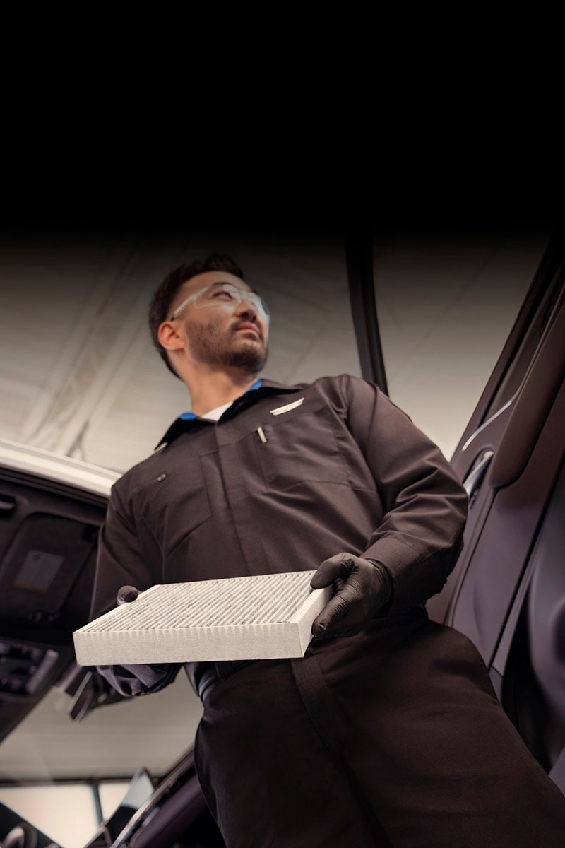 Cadillac Certified Service Technician Holding a Vehicle's Cabin Air Filter