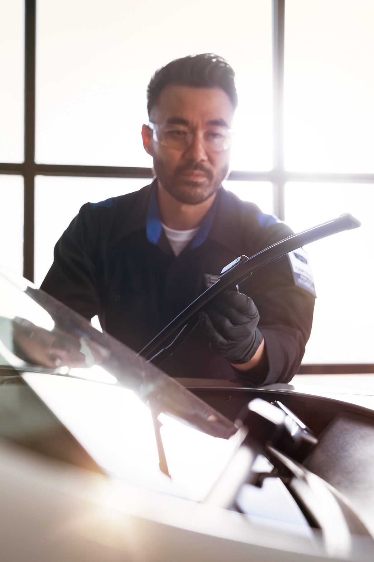 Cadillac Certified Service Technician Inspecting Windshield Wipers on a Vehicle