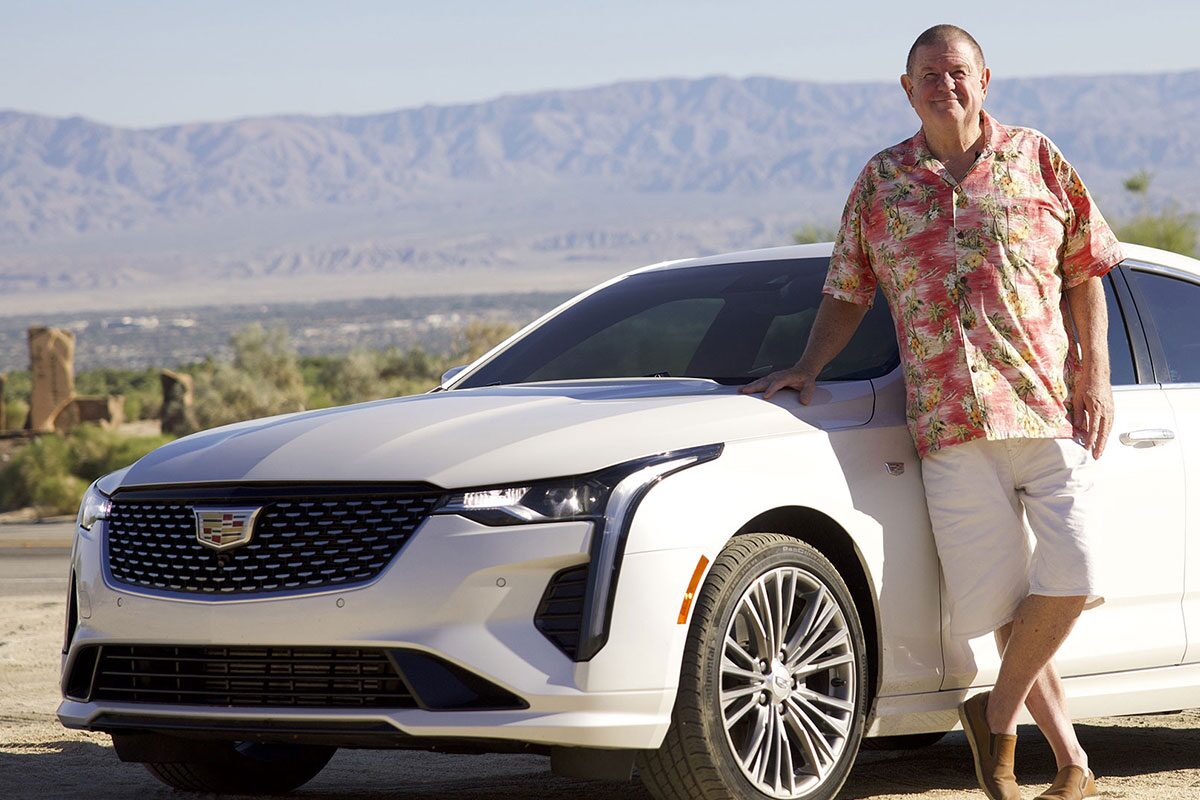 Rusty Austin standing next to his white 2021 Cadillac CT4