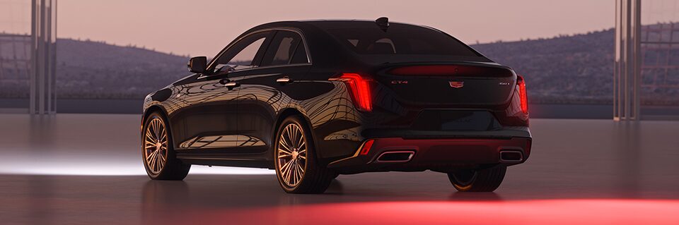 Three Quarters Rear View of a Black Cadillac Vehicle under an Evening Sky