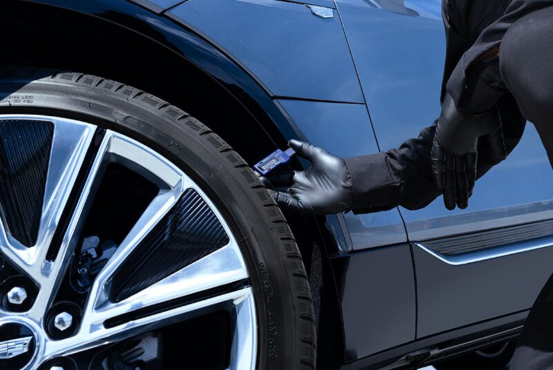 Close-up of a Maintenance Expert Checking a Tire with a Tool