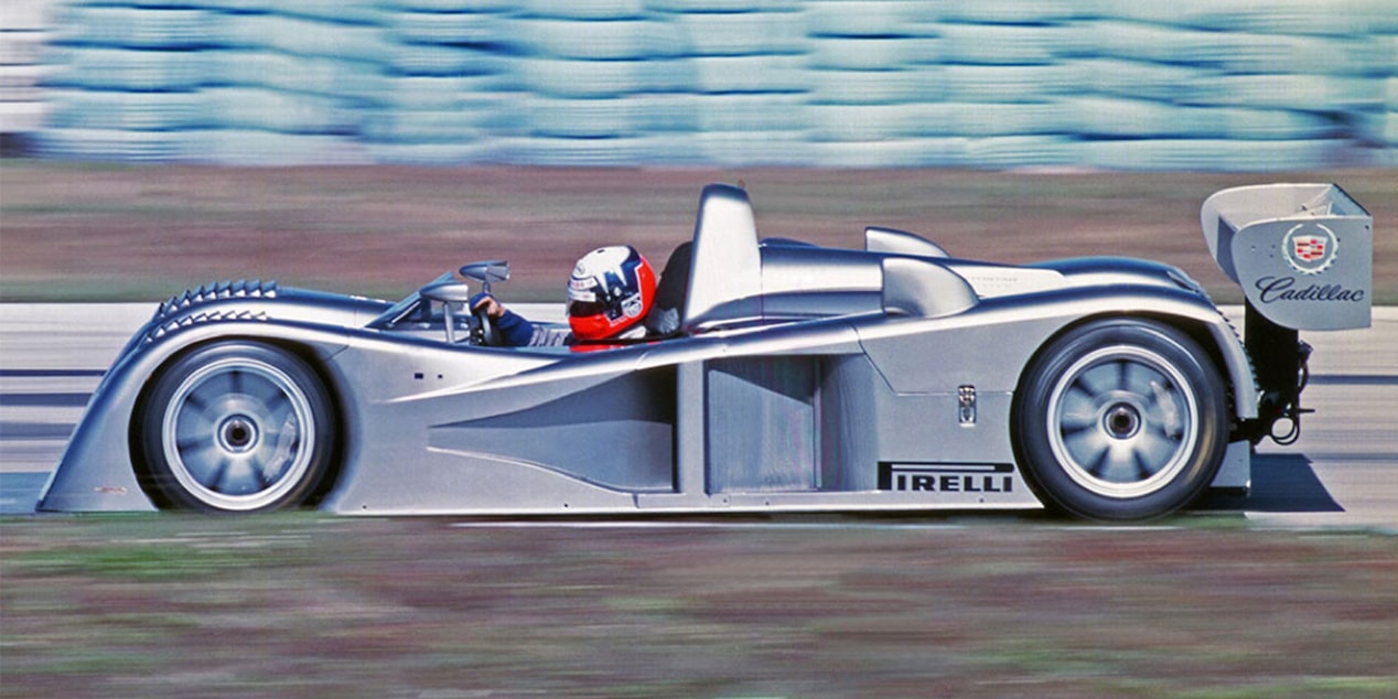 Side View of the Cadillac Northstar LMP Racecar Driving on a Track