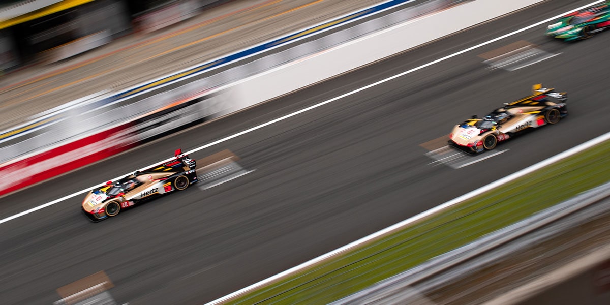 Birds Eye View of Staggered Cadillac Race Cars Speeding Around the Race Track
