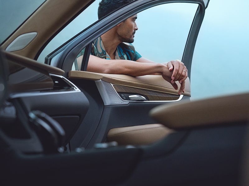 A Man Leans on the Open Passenger Window of His Cadillac XT6