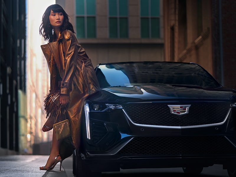 A Woman Leans on the Outside of the Her CT4 While in The City Center