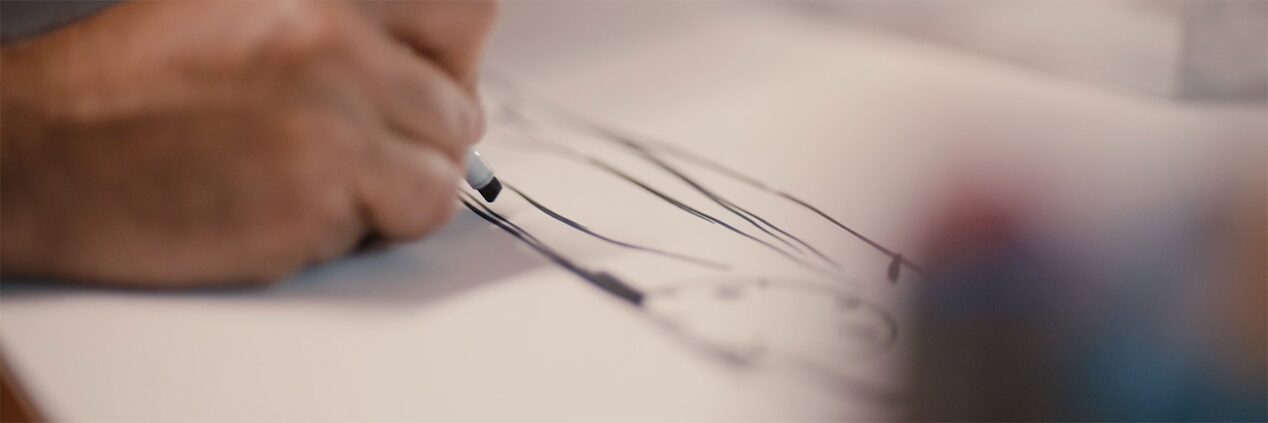 Person Sketching Cadillac Vehicle With Pencil