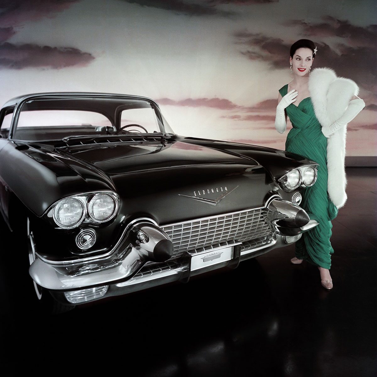 Woman In Glam Dress And Fur Jacket Posing Next To The Cadillac Eldorado