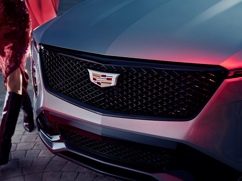 Close-up of a Woman Walking Past the 2025 Cadillac XT4 Grille
