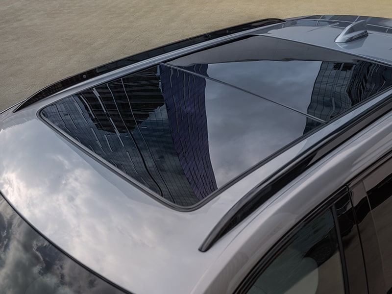 The Massive Sunroof of the 2025 Cadillac XT4 Reflecting the Clouds in the Sky