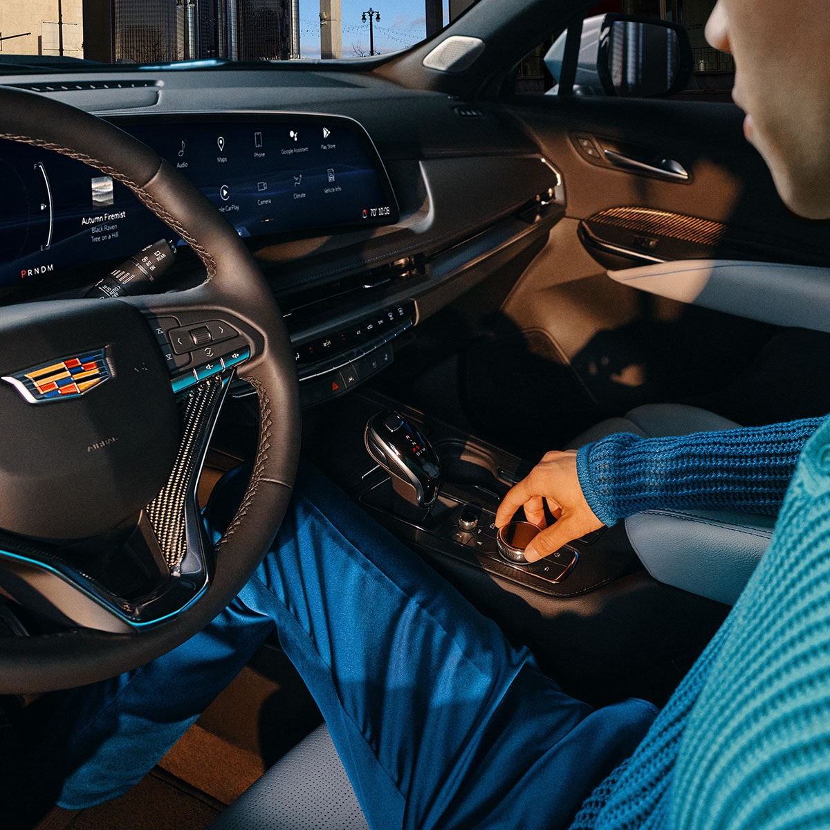 A Man Utilizing the Control Know on the 2025 Cadillac XT4 Middle Console