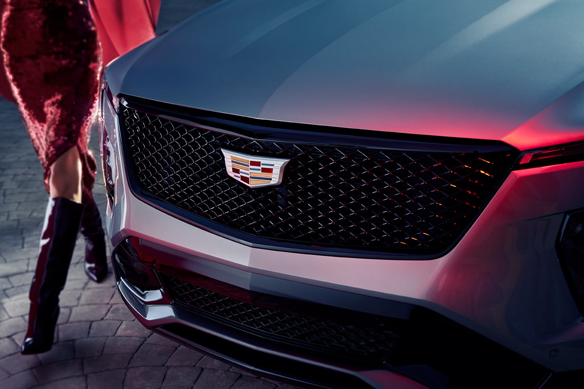 Close-up of a Woman Walking Past the 2025 Cadillac XT4 Grille