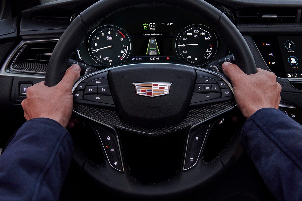 Driver's Hands Gripping the 2025 Cadillac XT5 Steering Wheel