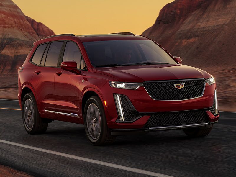 The Infrared Tricoat Cadillac XT6 Speeding Down a Desert Road by Canyons