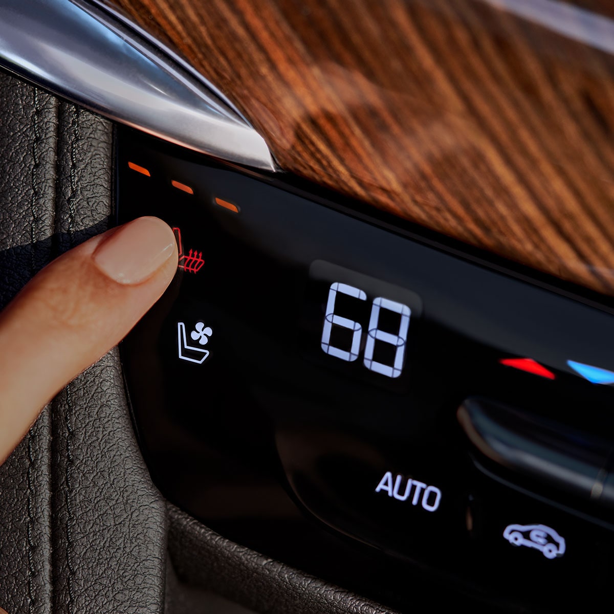 A Person Choosing Heated Rear Seats Function Inside of the New Cadillac XT6