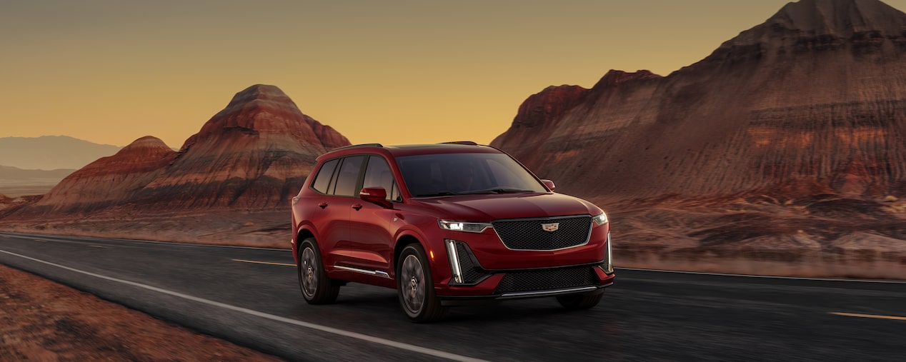 The Infrared Tricoat Cadillac XT6 Speeding Down a Desert Road by Canyons