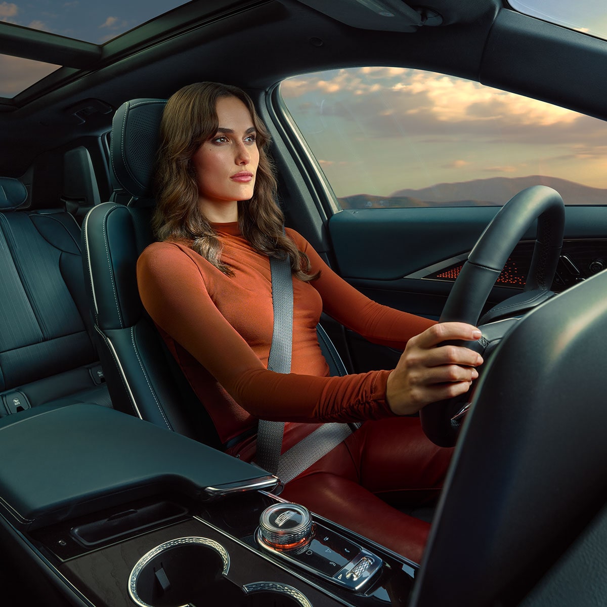 Dashboard View of a Woman Driving a 2025 Cadillac LYRIQ Overlooking the Mountains