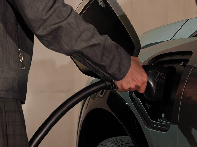 Close-up View of a Man Charging a 2025 Cadillac OPTIQ