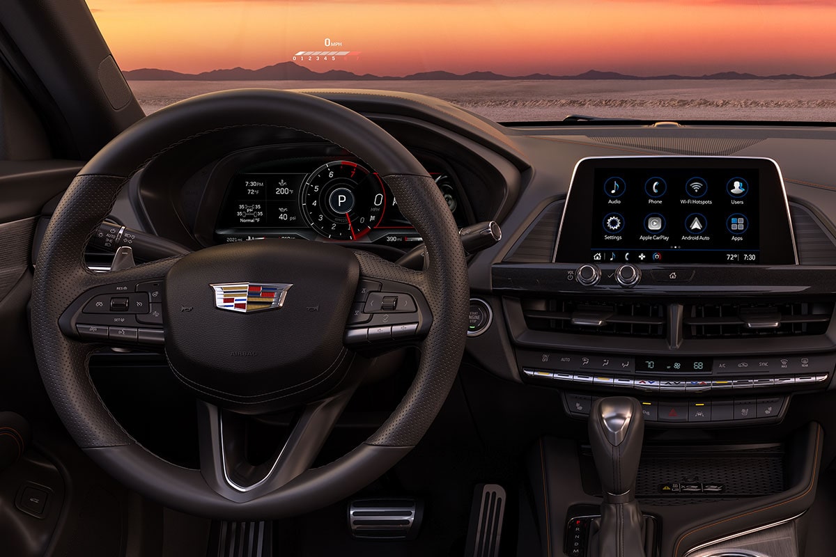 Driver's View of the 2025 CT4 Sleek Infotainment System and Steering Wheel