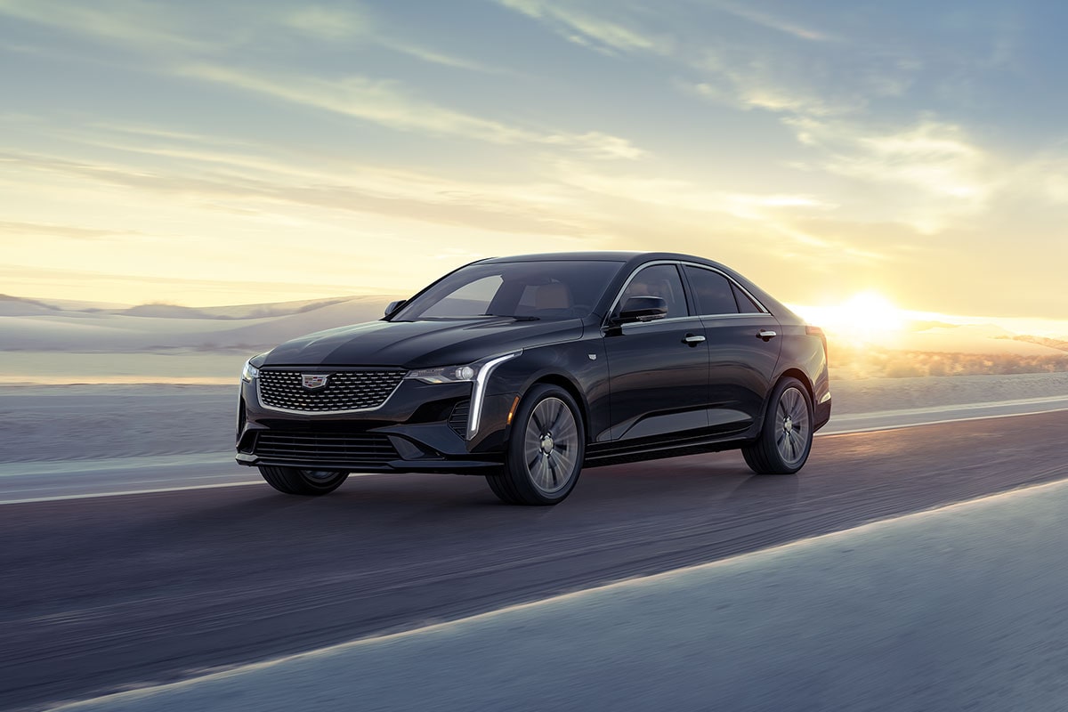 Three Quarters View of a 2025 CT4 Driving Through The Desert During a Sunrise